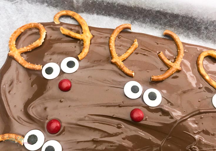 reindeer chocolate bark with pretzel horns, candy eyes and a red candy nose