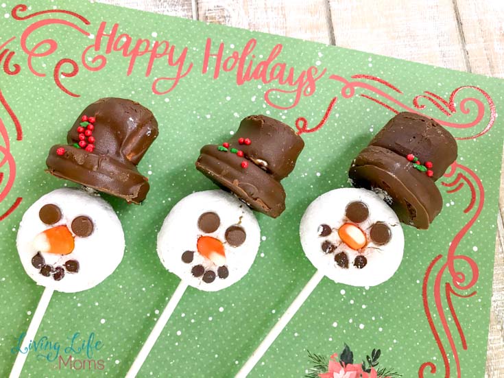 These Snowman Donut Pops are a simple and fun holiday treat that the entire family will love! No baking required, you'll fall in love with the taste and look of these edible snowmen!  #snowman #donuts #holidaytreats #winter #LivingLifeasMoms