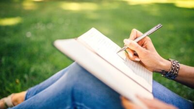 Woman writing in park Brain Dump