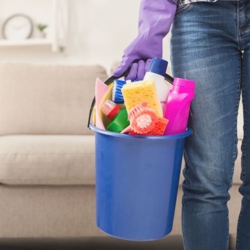 person holding cleaning supplies