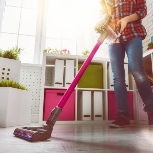 person vacuuming floor