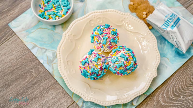 three mermaid hot chocolates bombs on a white plate