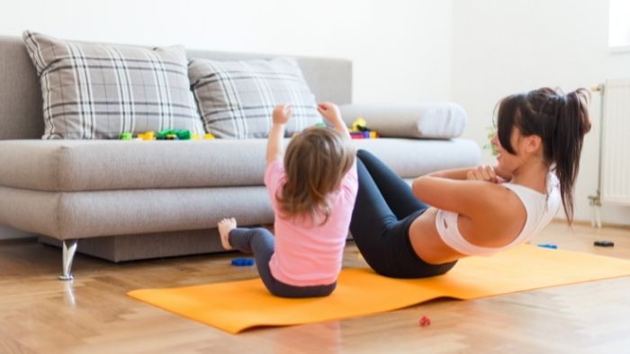 mom and child exercising in livingroom