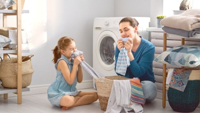 mom and child smelling laundry