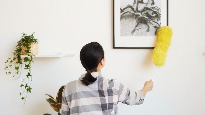 mom dusting a picture 