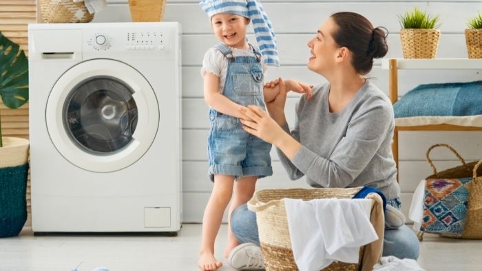 mom and child in laundry room